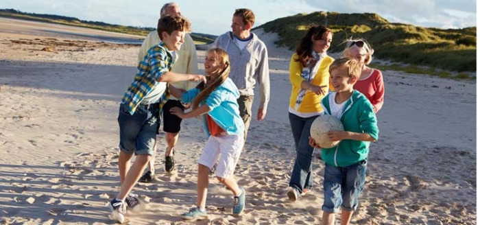 Grofamilie am Strand nach eingehender Planung des Urlaubs