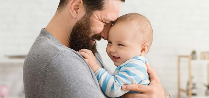 Vater hält Baby sicher im Arm Vater hält Baby sicher im Arm